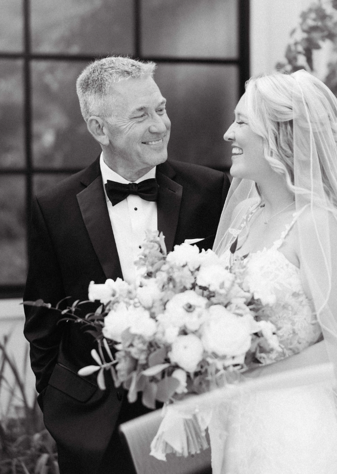 Father and daughter looking at each other and smiling on wedding day for joyful North Georgia wedding